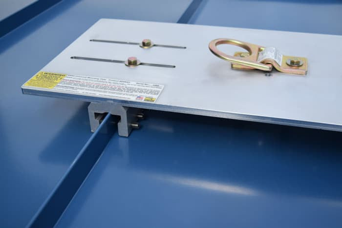 Metal platform with safety latches on a blue surface